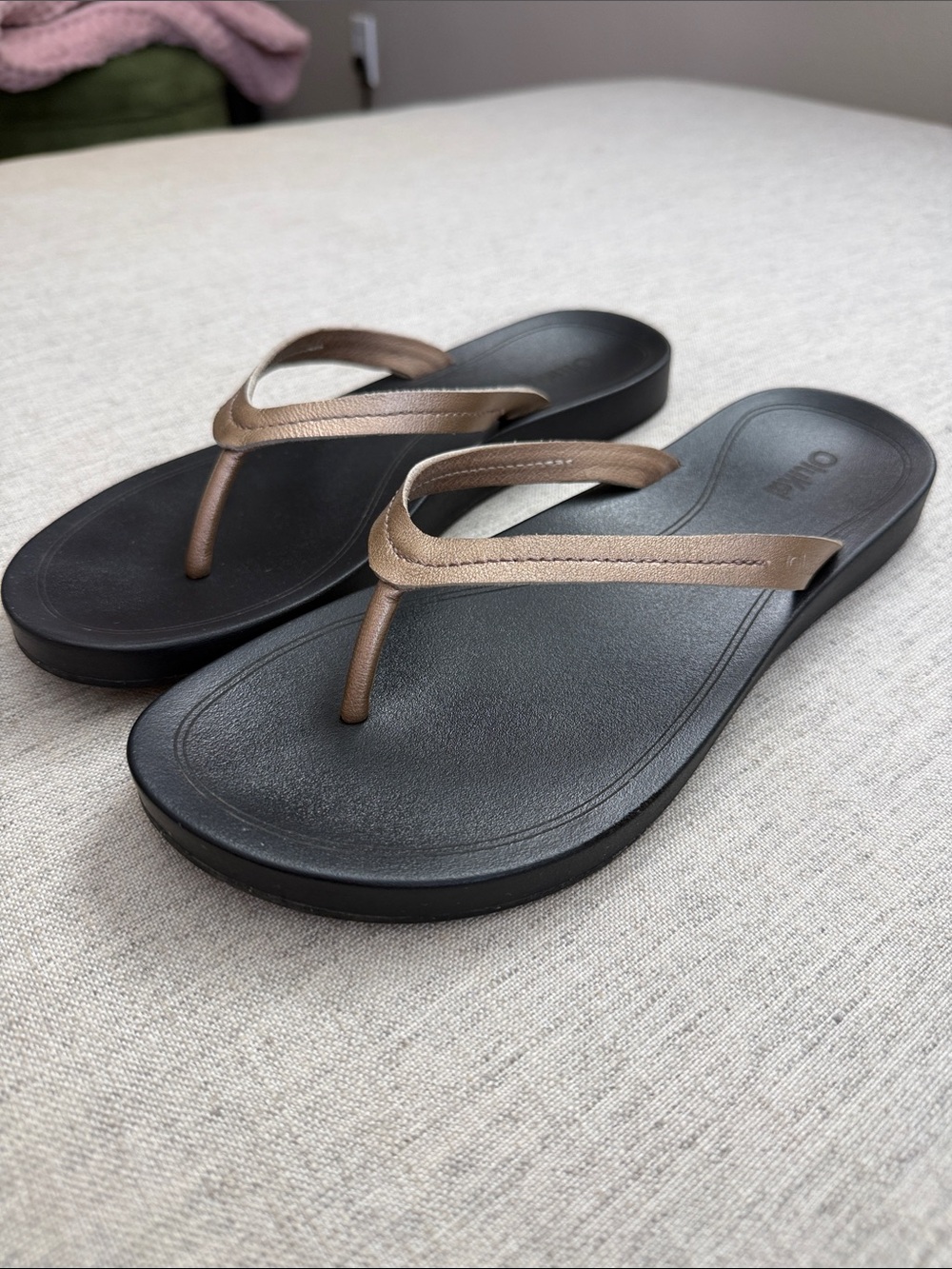 OluKai Black Footbed Sandals with Metallic Rose Gold Straps